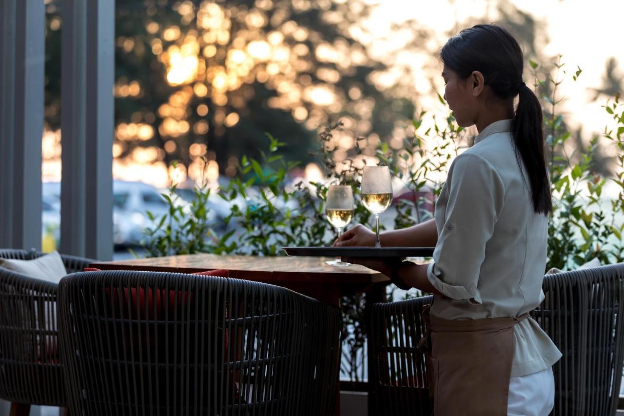 Outrigger Surin Beach Resort - Sha Extra Plus Екстер'єр фото A waitress clearing a table